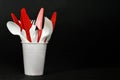 Plastic cutlery. Forks, spoons and knives in disposable plastic cup Royalty Free Stock Photo