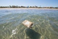 Plastic deposit in ocean next to beach