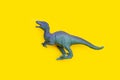 Plastic dinosaur toy on yellow Royalty Free Stock Photo