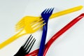 Closeup of colorful plastic disposable forks on a white background. Royalty Free Stock Photo