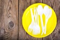 Plastic disposable tableware on wooden table Royalty Free Stock Photo