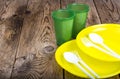 Plastic disposable tableware on wooden table Royalty Free Stock Photo