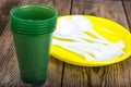 Plastic disposable tableware on wooden table Royalty Free Stock Photo