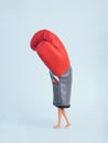 Plastic doll legs walking in heavy red boxing glove