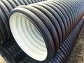 Plastic drain corrugated pipes pvc in a pile Royalty Free Stock Photo