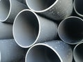 Plastic drain pipes pvc in a pile Royalty Free Stock Photo