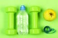 Plastic dumbbells, clear bottle and fruit. Sport and fitness concept. Royalty Free Stock Photo