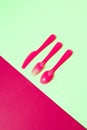 Dining set from colored plastic cutlery on a duotone background. Royalty Free Stock Photo