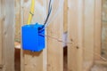 Plastic electrical switch box with wires at wooden frame beams Royalty Free Stock Photo