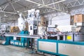 Plastic extrusion manufacturing machine in modern industrial factory, automated polymer processing line for plastic Royalty Free Stock Photo