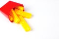 Plastic fast food, French fries toy on white background. Unhealthy. Not organic Royalty Free Stock Photo