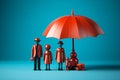 Plastic figures in the form of a family protected by a red umbrella. Insurance concept