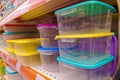 Plastic food containers on a shelf in a store. Colorful containers on a shelf. Abstract background Royalty Free Stock Photo