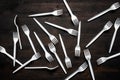 Plastic forks scattered on wooden table Royalty Free Stock Photo