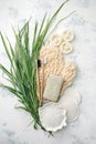 Plastic free background. Personal care products made from natural materials: bamboo tooth brushes, cotton pads, soap, green leaf. Royalty Free Stock Photo