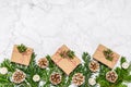 Plastic free Christmas flat lay with conifer tree branches, pine cones and handmade giftboxes on marble background. Greeting card Royalty Free Stock Photo