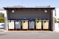 Plastic garbarge cans under a hut for disposal Royalty Free Stock Photo
