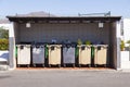 Plastic garbarge cans under a hut for disposal Royalty Free Stock Photo