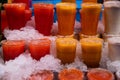 Plastic glasses of blended fresh juices on ice