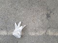 Plastic glove on asphalt parking lot of the mall