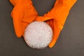 Plastic granules . Polyethylene pellets and hands with orange gloves. Quality control of plastic in the laboratory in the
