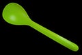 Plastic green spoon on white