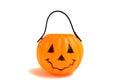 A plastic Halloween cup in the shape of a pumpkin with a face features Royalty Free Stock Photo