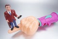 Plastic Hand with Businessman Figurine Royalty Free Stock Photo