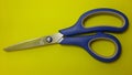 plastic handle paper scissors, paper cutting scissors, yellow background Royalty Free Stock Photo