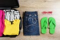 Plastic hardshell suitcase packed with casual clothing items