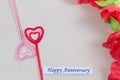 The plastic heart pairs with the happy anniversary card, with many flowers