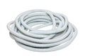 Plastic hose isolated. Close-up of a roll of light gray industrial flexible plastic corrugated pipe for electrical cable Royalty Free Stock Photo