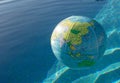 Plastic, inflatable globe floating in a swimming pool