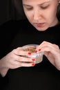 Plastic jar with hemp seeds in woman's hands