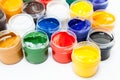 Plastic jars of colored paints on white background Royalty Free Stock Photo