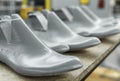 Plastic lasts used in the manufacture of shoes. Row of plastic shoe lasts used to manufacture modern day shoes. A lot of