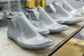 Plastic lasts used in the manufacture of shoes. Row of plastic shoe lasts used to manufacture modern day shoes. A lot of