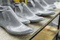 Plastic lasts used in the manufacture of shoes. Row of plastic shoe lasts used to manufacture modern day shoes. A lot of