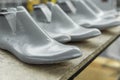 Plastic lasts used in the manufacture of shoes. Row of plastic shoe lasts used to manufacture modern day shoes. A lot of