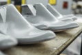 Plastic lasts used in the manufacture of shoes. Row of plastic shoe lasts used to manufacture modern day shoes. A lot of