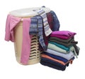 Plastic laundry basket, from under the cover of which you can see different clothes and a stack of clothes next to the floor Royalty Free Stock Photo