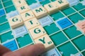 Plastic letters on Scrabble board game forming the words : Strategy and gamer