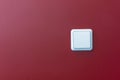 Plastic light switch in the red wall Royalty Free Stock Photo