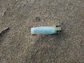 Plastic lighter trash on sandy sea ecosystem,microplastics sea coast pollution Royalty Free Stock Photo