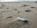 Plastic lighter trash on sandy sea ecosystem,microplastics industrial pollution Royalty Free Stock Photo