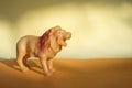 Plastic lion figurine in orange background