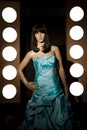 Plastic mannequin with a blue princess ball gown posing between rows of spotlights Royalty Free Stock Photo