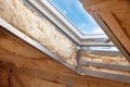 Plastic mansard or skylight window on attic with environmentally friendly and energy efficient thermal insulation rockwool Royalty Free Stock Photo