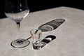 Plastic marble imitation table in restaurant terrace after dinner with empty wine glass and empty appetizer Grappa Ouzo