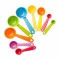 A plastic measuring spoon set in bright colors, scattered composition, isolated Royalty Free Stock Photo